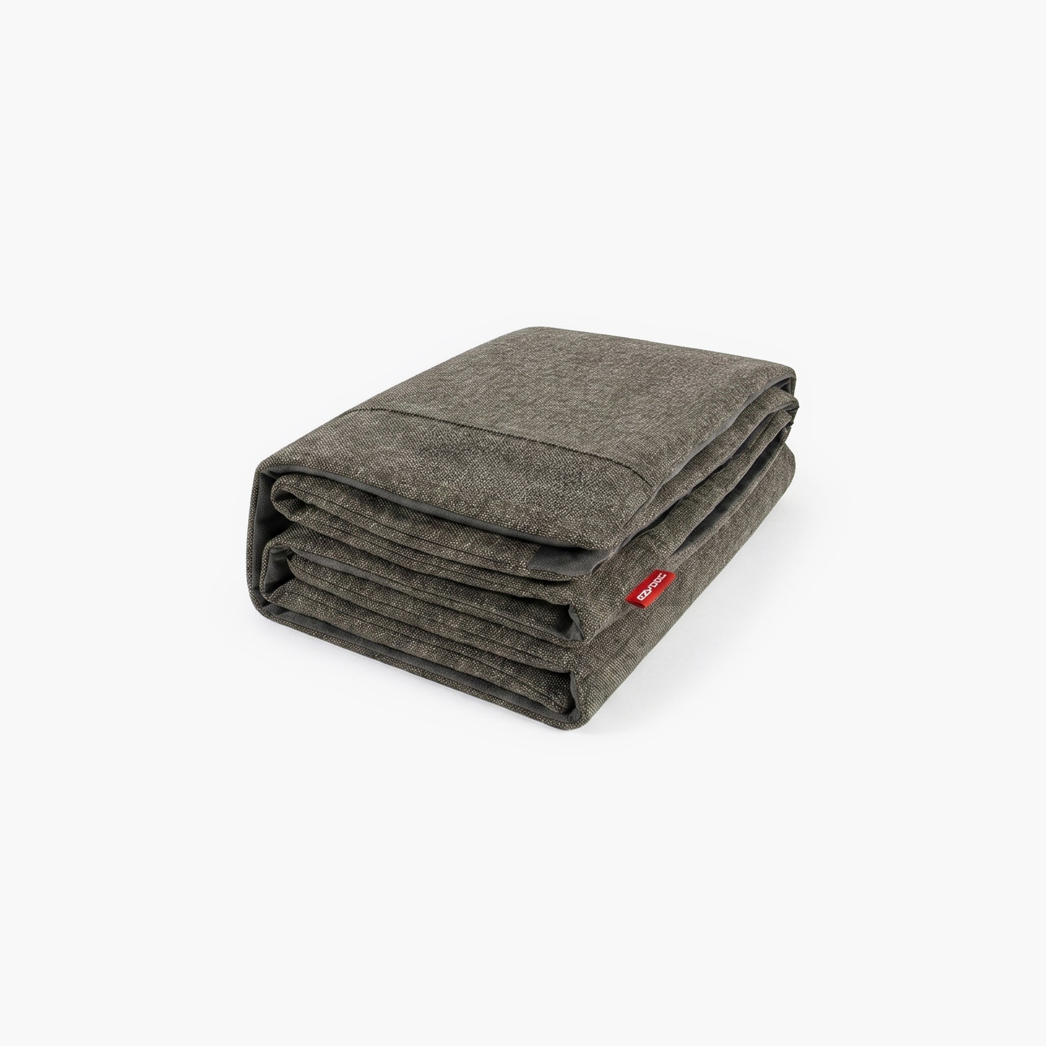 Folded gray dog bed cover with a red tag on a white background