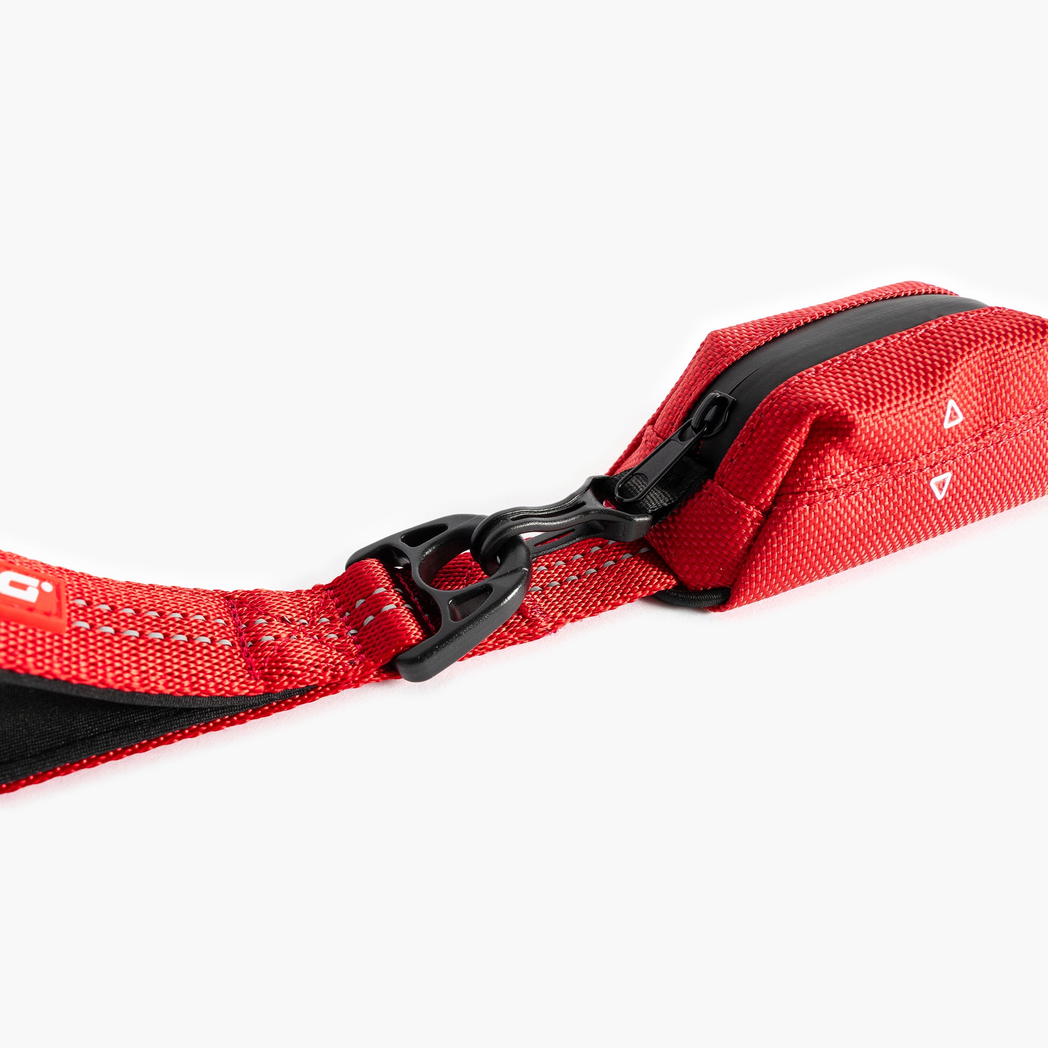 Red dog leash with black clip on a white background