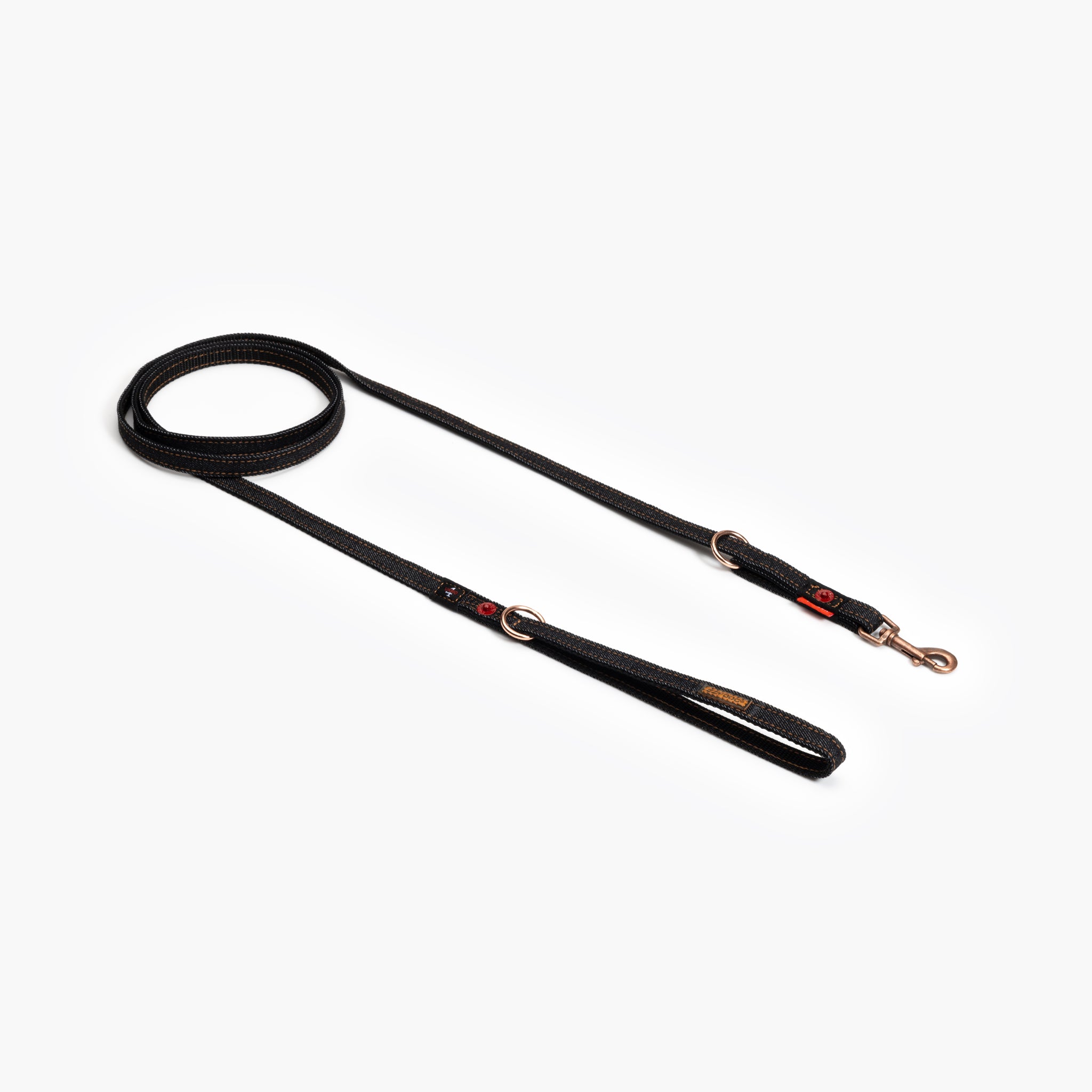 A denim black multi-function dog leash laid out on a plain background, showing both the handle and the metal clasp.