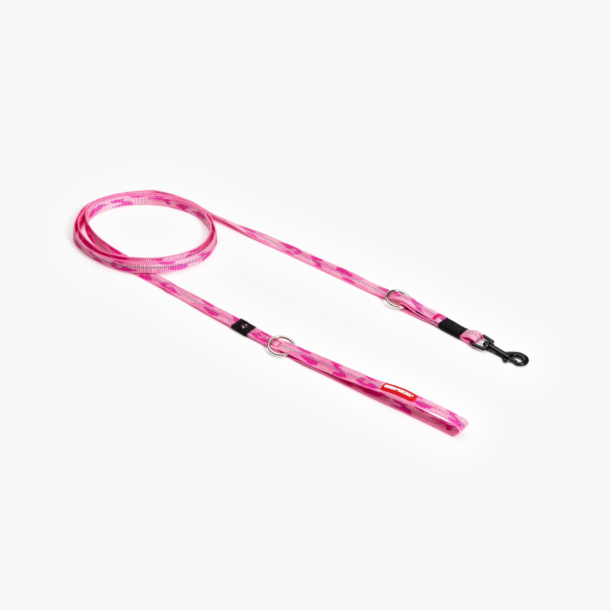 A pink camouflage multi-function dog leash laid out on a white background, featuring adjustable straps and metal clasps.