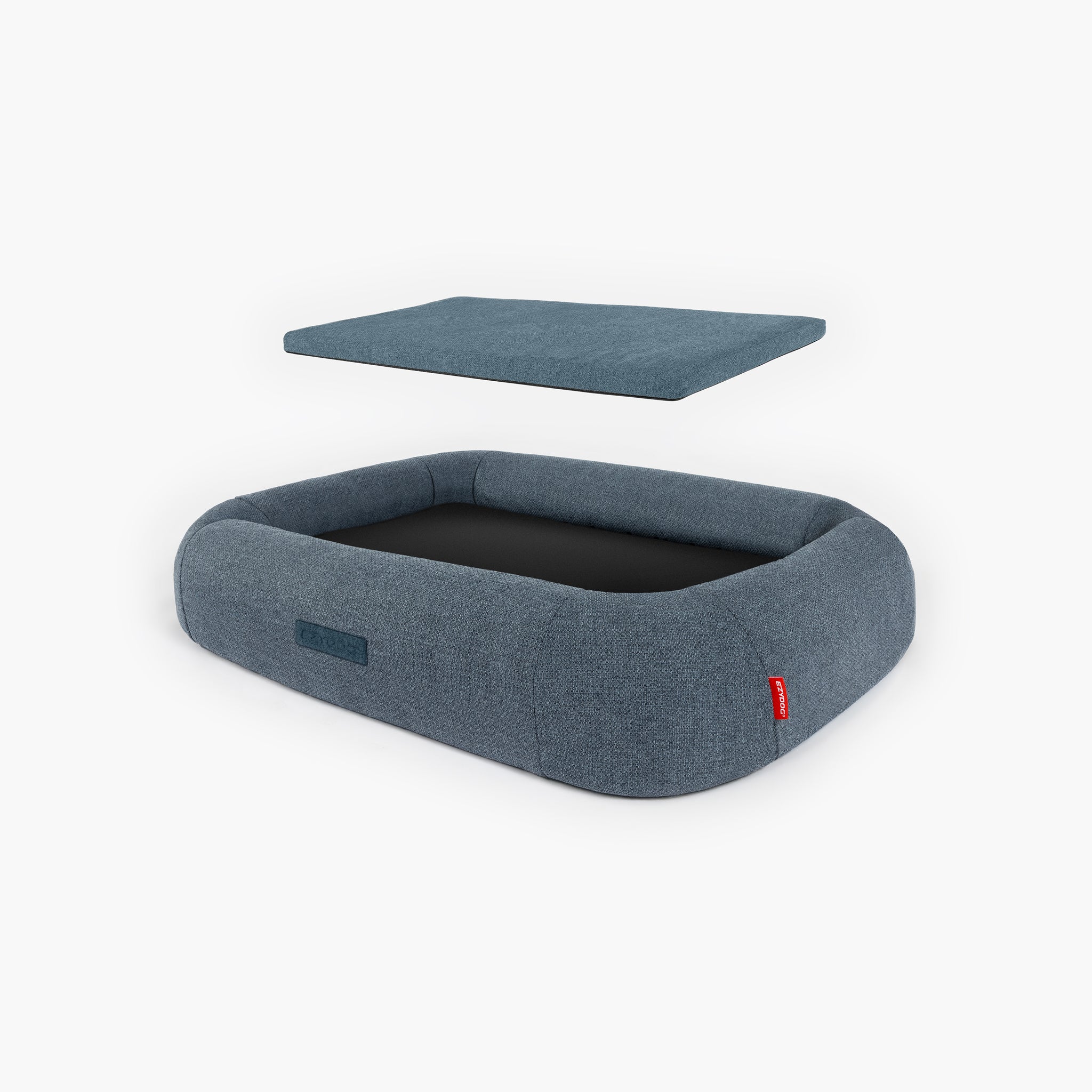 Blue dog bed with a detachable cushion on a white background