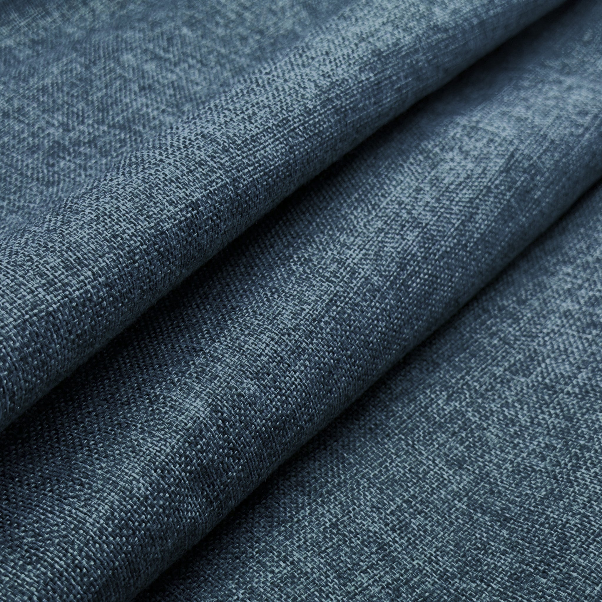 Close-up of blue denim fabric with a subtle pattern