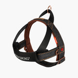 A denim dog harness with brown straps and a quick-fit buckle system, featuring neoprene padding on the chest.